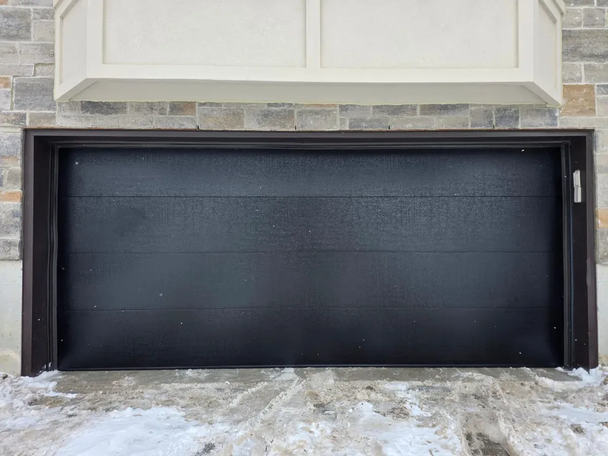 Black modern flush-panel double garage door — Vaughan