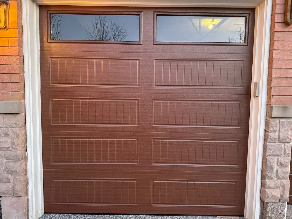 Brown woodgrain single garage door with top windows — Mississauga