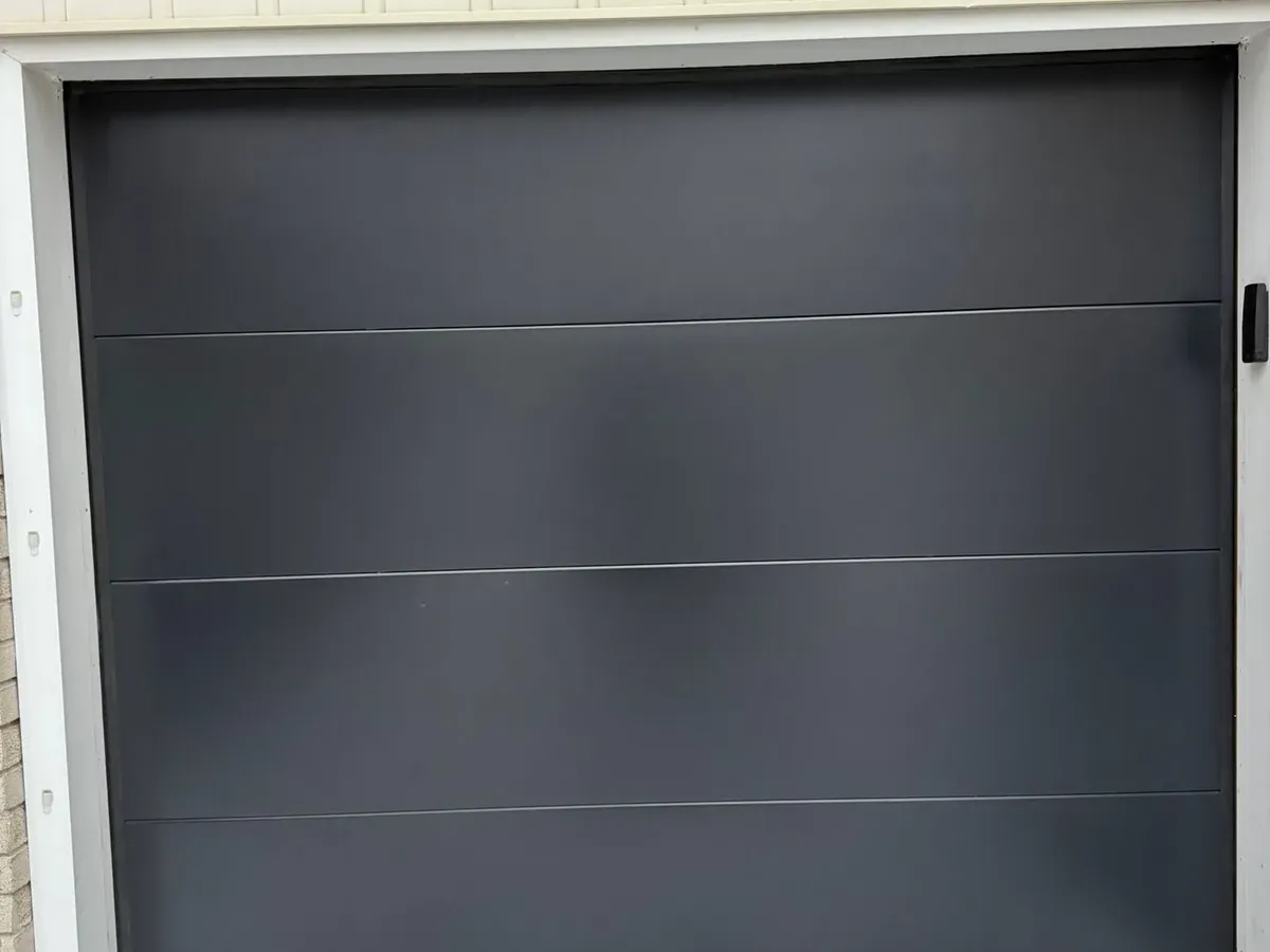 Charcoal modern flush-panel garage door — North York