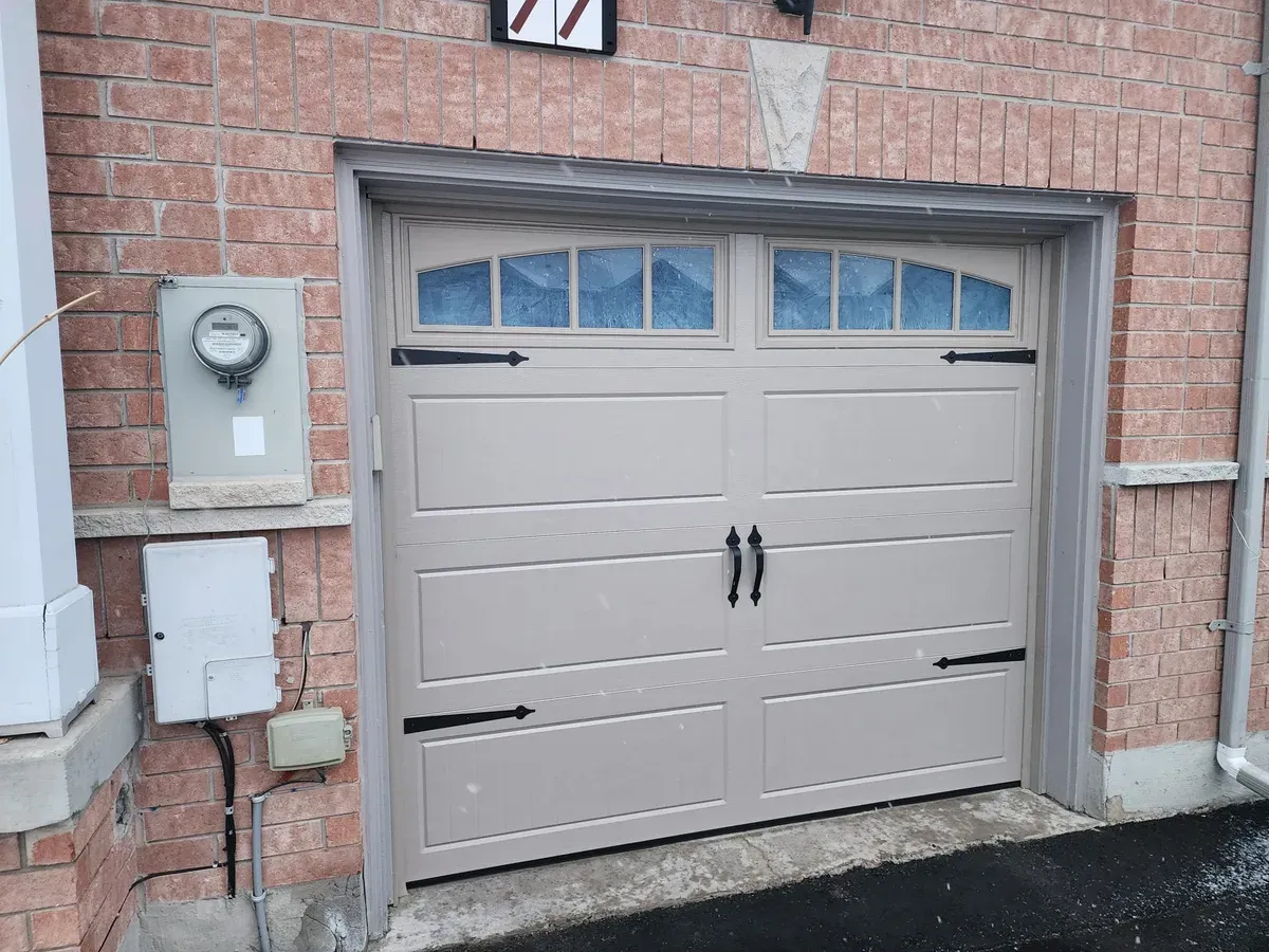 Cream carriage garage door with arch windows — Brampton