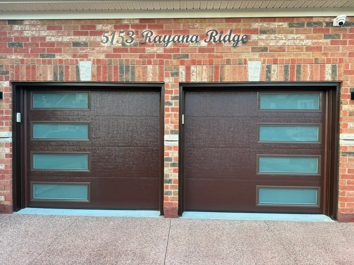 Dark brown modern flush-panel garage doors with frosted side windows — GTA