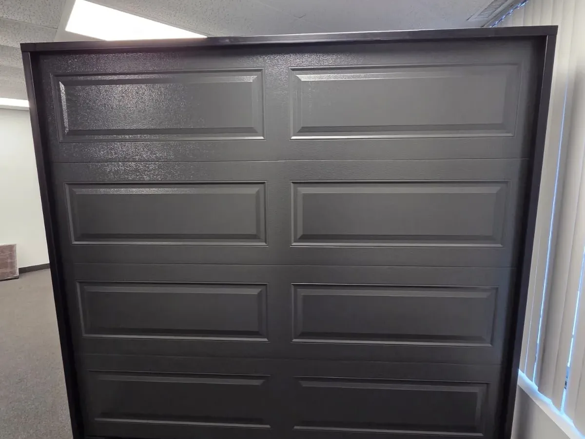 Dark charcoal raised-panel garage door on display in our showroom