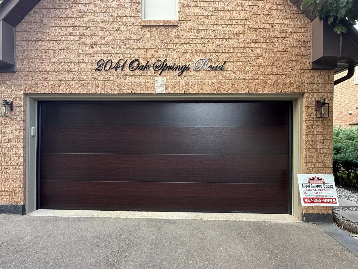 Dark walnut flush-panel double garage door installation — Oakville