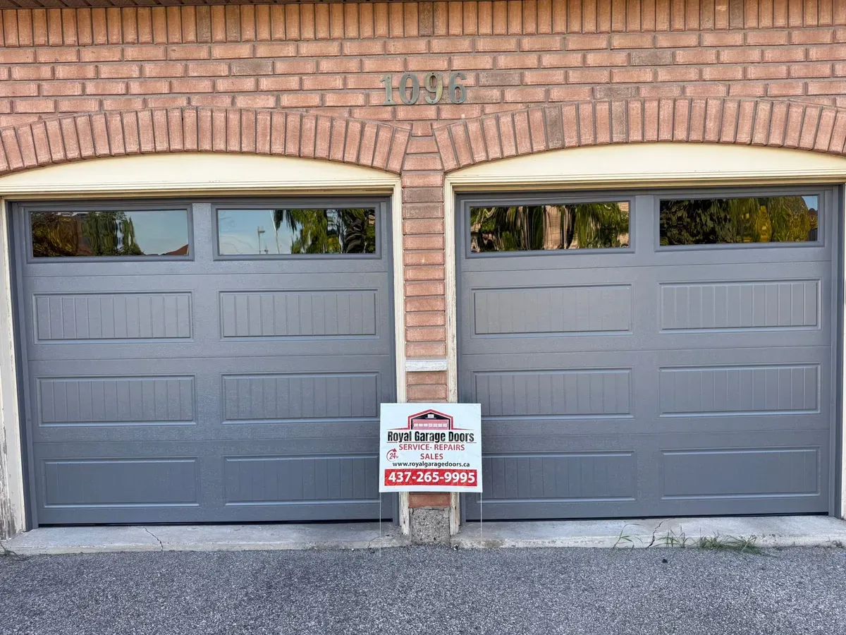 Grey double sectional garage door installation — Brampton