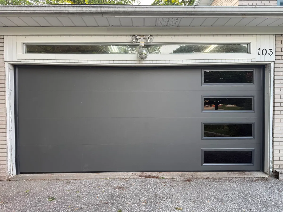Grey modern flush-panel double garage door with side windows — GTA
