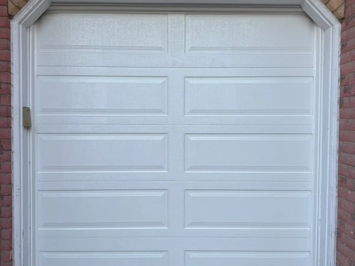 White single sectional garage door replacement — Toronto