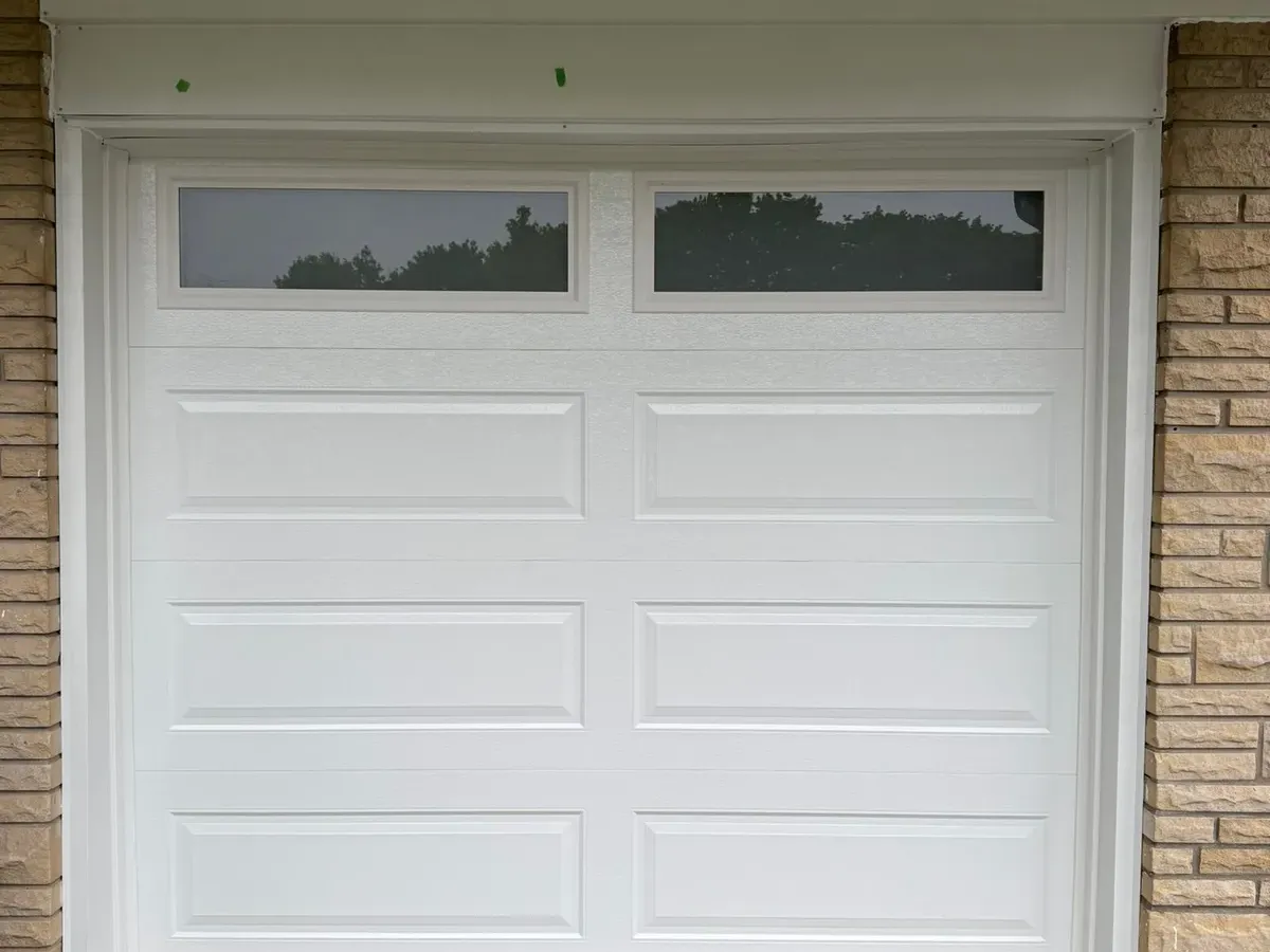 White single sectional garage door with top windows — Toronto